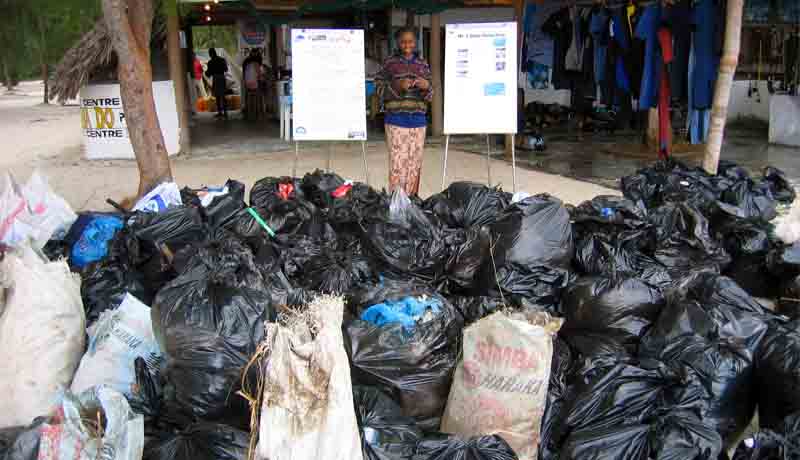 Instructor Grace standing next to the rubbish collected on Scuba Do Zanzibar's 2005 Beach and Underwater cleanup
