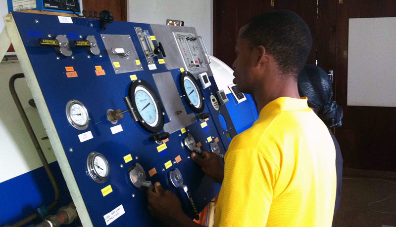 Student at control panel on hyperbaric chamber