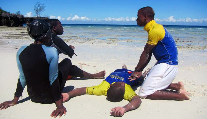 Scuba Do Zanzibar instructor demonstrating CPR to Chumbe Island Rangers