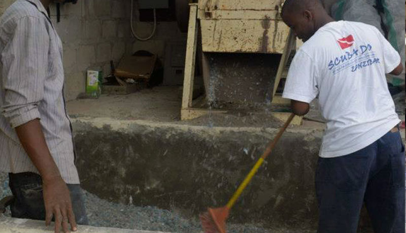 Scuba Do Zanzibar crew sweeping up the shredded plastic