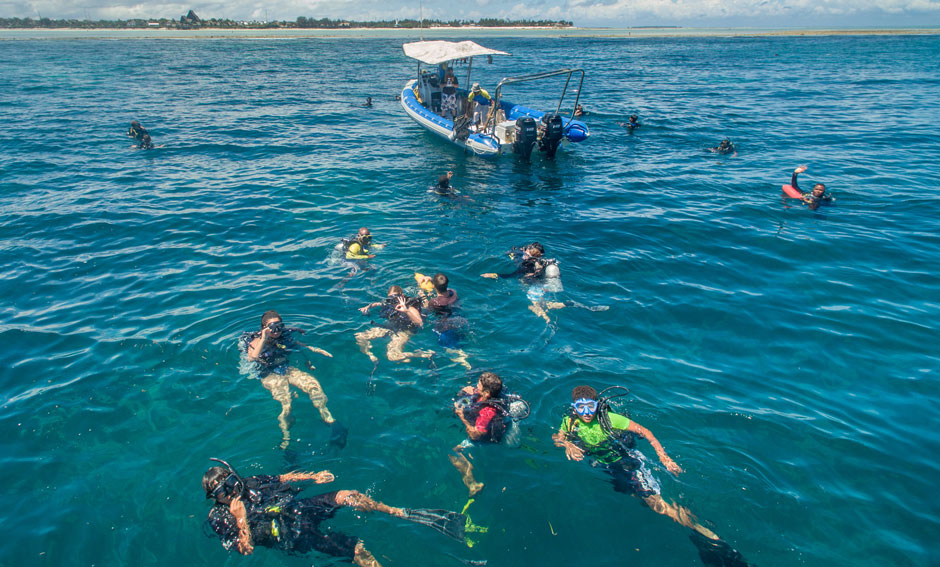 Students with instructors on the surface about to descend on their coral reef monitoring dive