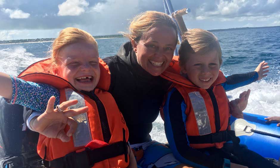 Two ecstatic young snorkellings with instructor on speedboat journey to reef
