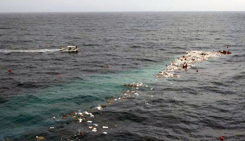 Photo taking by helicopter pilot involved in the rescue of Scuba Do Zanzibar's boat approaching the survivors floating in the wreckage.